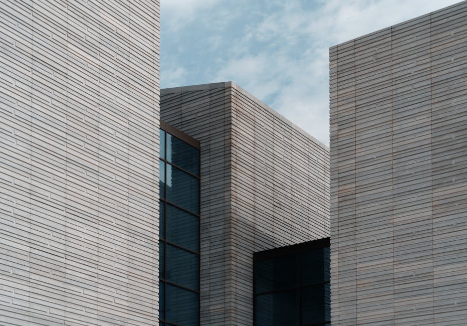 Contemporary minimalist building facade with clear sky background, architectural elegance