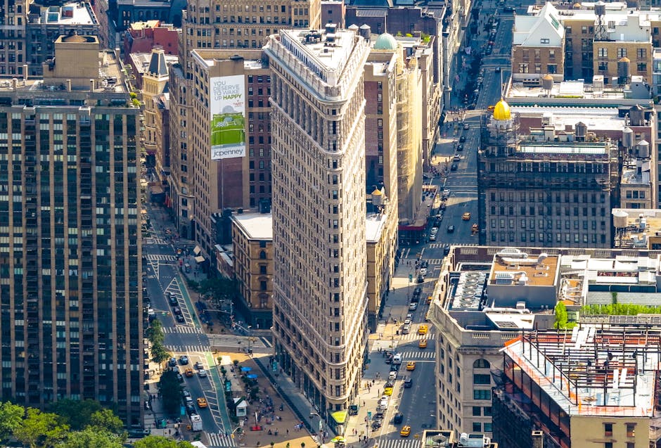 Stunning aerial view of the iconic Flatiron Building surrounded by Manhattan's bustling cityscape