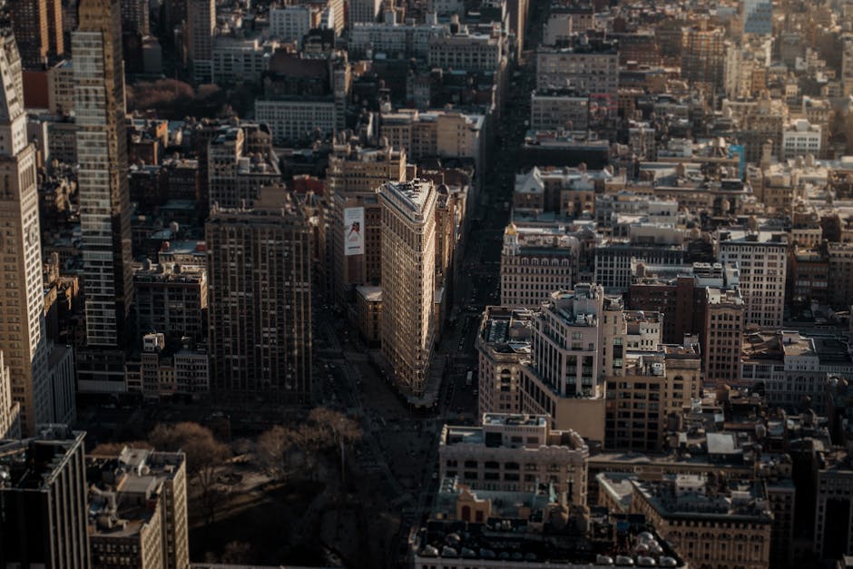A stunning aerial view highlighting the Flatiron Building amidst the bustling cityscape of New York City